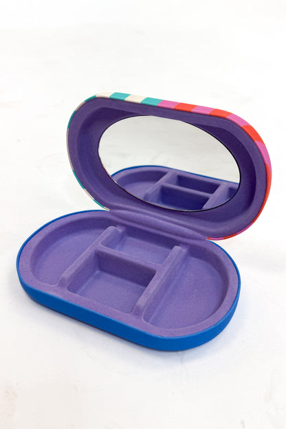 Purple and blue jewelry organizer with a mirror on a white background