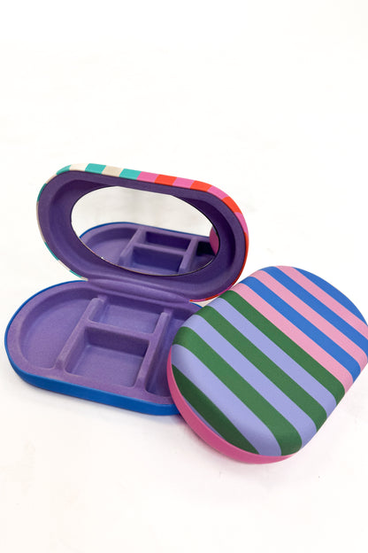 Colorful striped jewelry case with mirror on a white background
