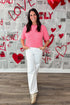 Front view of woman wearing Pink With Pearl Heart Detail Sweater with jeans against Valentine&