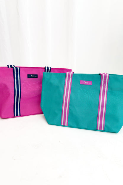 Two bags, one pink and one teal, with visible branding on a white background