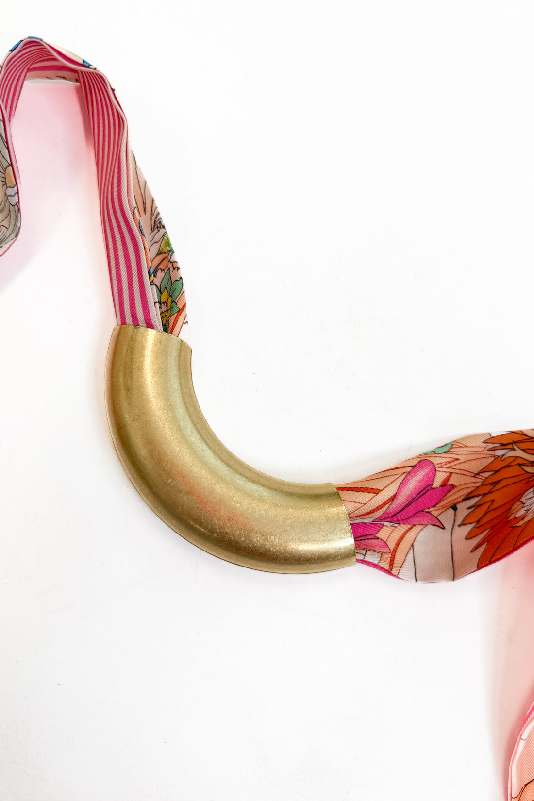decorative scarf with the lanie curved metal accessory added to it against a white background