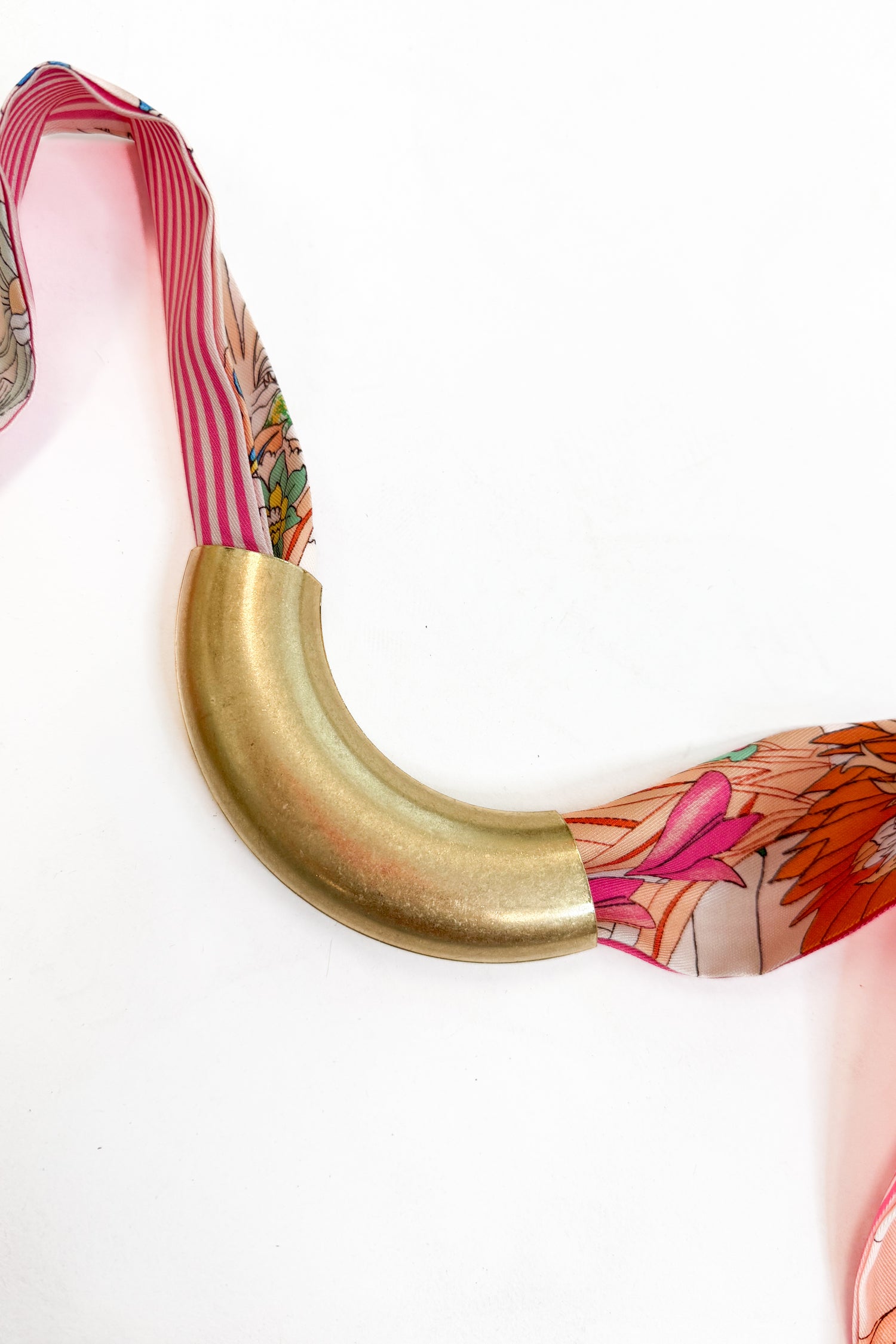 decorative scarf with the lanie curved metal accessory added to it against a white background