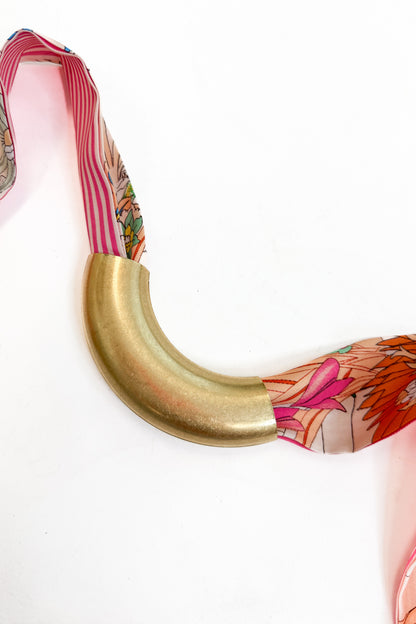 decorative scarf with the lanie curved metal accessory added to it against a white background