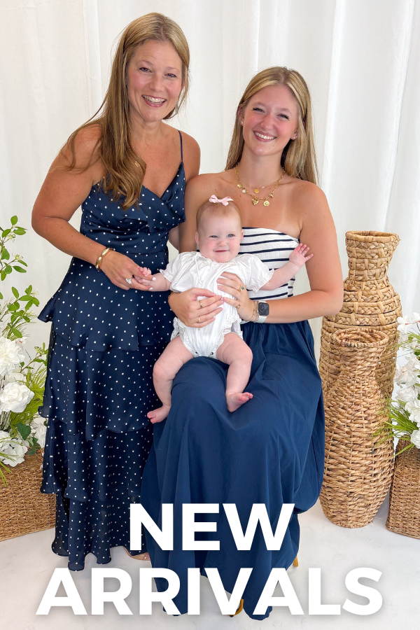 two women holding a baby against a white background with "new arrivals" text overlay