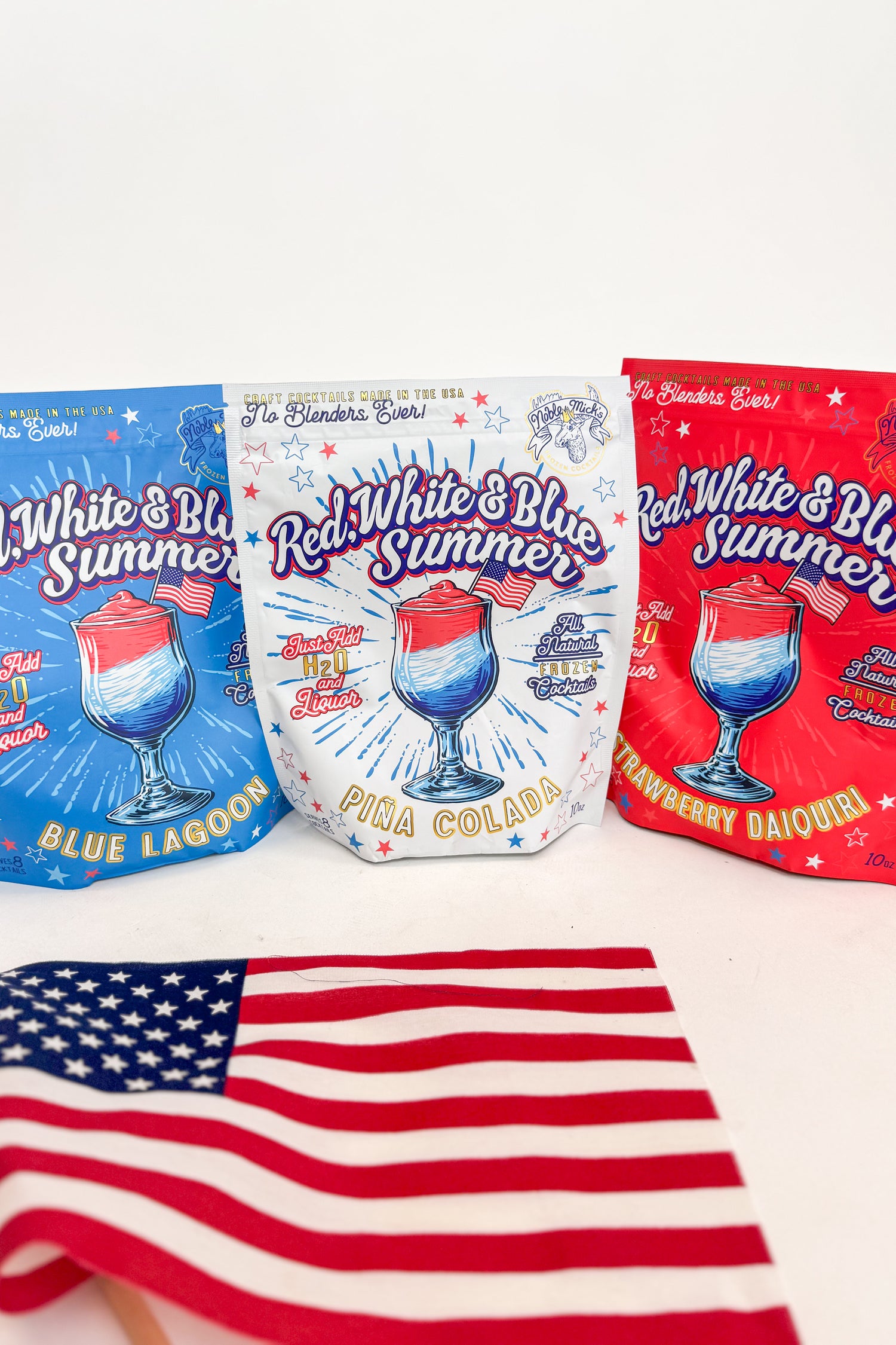 Three colorful packaging designs for drink mixes with a red, white, and blue theme, featuring an American flag in the foreground.