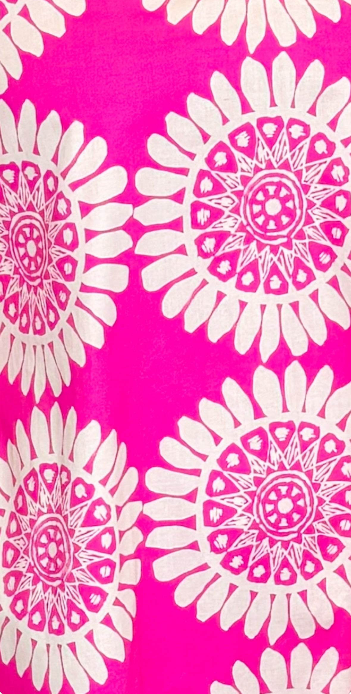 detail shot of pink dress with white floral print design