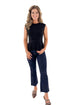 Front view of woman wearing Black Suede Belted Peplum Top with jeans against white studio background.