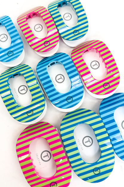 Colorful striped round flat teletie hair clips on a white background