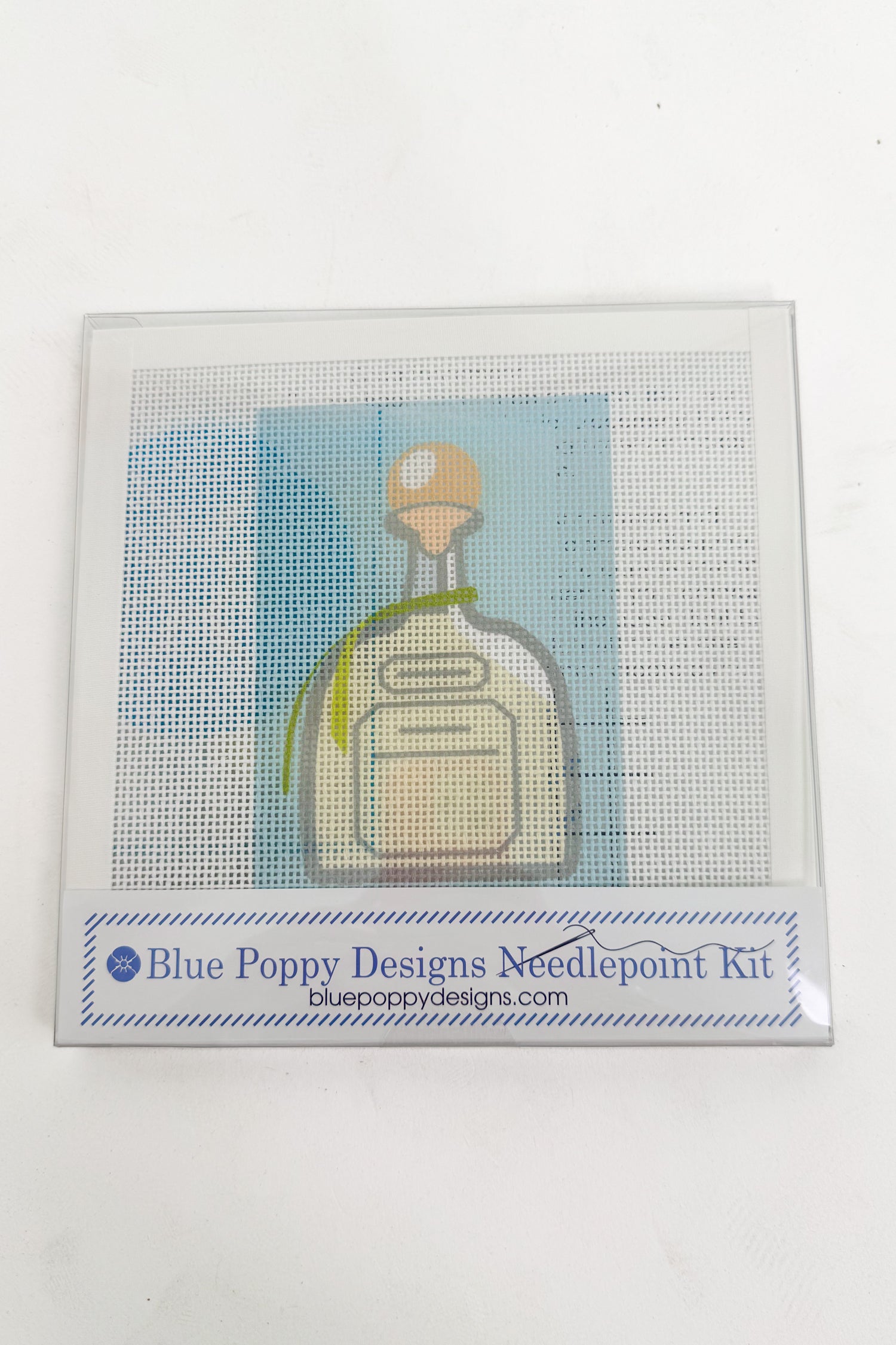 Blue Poppy Designs needlepoint kit with a bottle design on a white background