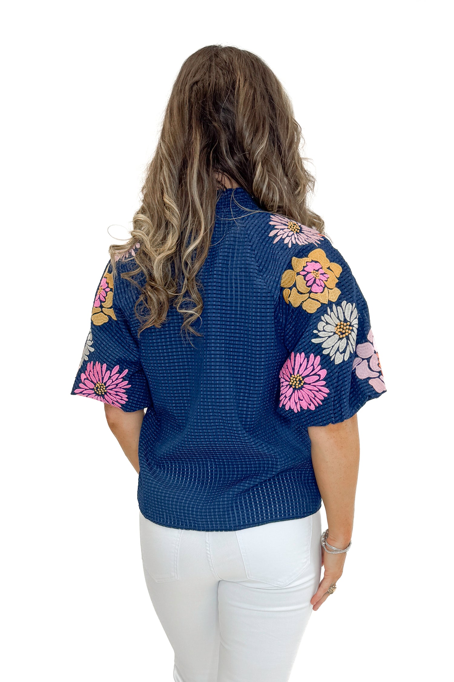 Back view of woman wearing Navy Textured &amp; Floral Embroidered Top by THML with jeans against white studio background.