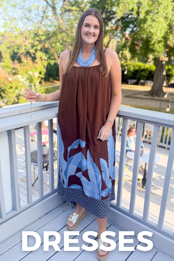 Woman in a brown and blue dress standing on a balcony with 'DRESSES' text overlay.